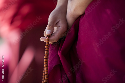 Photo: Prayer beads in monk's hand Prayer beads in monk's hand