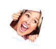 Happy young woman looking through a hole.