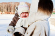 mum with crying baby outside in cold