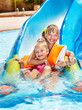 Children on water slide at aquapark.