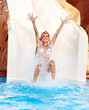 Child on water slide at aquapark.