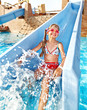 Child on water slide at aquapark.