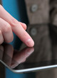 finger on tablet computer screen