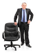 Full length portrait of a mature businessman standing next to a Full length portrait of a mature businessman standing next to a