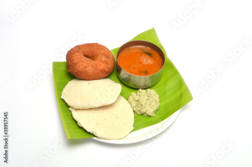 Photo: Idli vada with sambar and chutney served on banana leaf Idli vada with sambar and chutney served on banana leaf