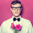 Young beautiful man with flowers
