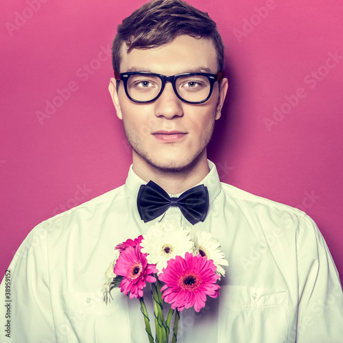 Photo: Young beautiful man with flowers Young beautiful man with flowers