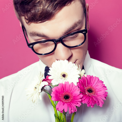 Photo: Young beautiful man with flowers Young beautiful man with flowers