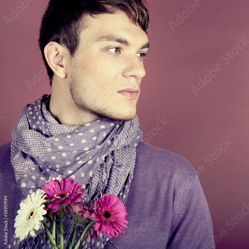 Photo: Young beautiful man with flowers Young beautiful man with flowers