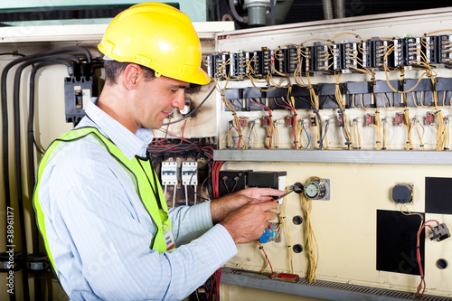 Photo: electrician changing industrial machine switch electrician changing industrial machine switch