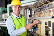 Photo: technician repairing industrial machine control box technician repairing industrial machine control box