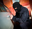 robber and the thief in a mask hijacks the car