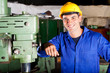 happy industrial artisan portrait in workshop