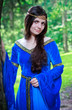 Photo: beautiful princess standing near big tree beautiful princess standing near big tree