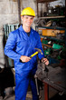 happy blue collar worker working in workshop