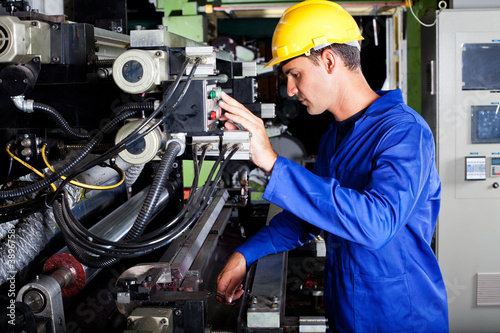 Photo: operator operating industrial printing press operator operating industrial printing press