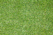 Background texture with fake grass in a public children playgrou Background texture with fake grass in a public children playgrou