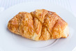The fresh croissant isolated on white plate The fresh croissant isolated on white plate