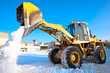 Photo: Wheel loader machine unloading snow during municipal works crews Wheel loader machine unloading snow during municipal works crews
