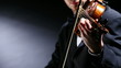 the violinist: Musician playing violin on dark background