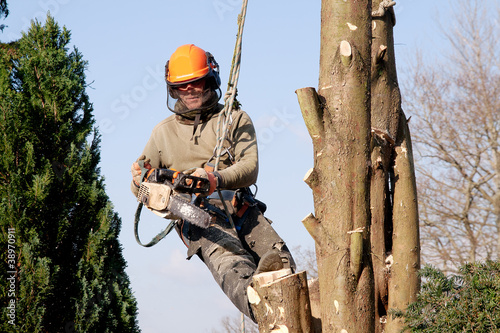 Photo: Man starting chainsaw Man starting chainsaw