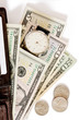 Wallet with money and watch on white background.