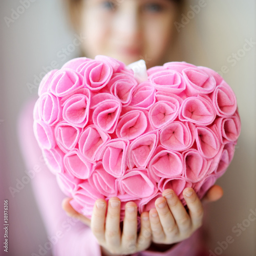 Photo: Pretty toddelr girl holding pink heart pendant Pretty toddelr girl holding pink heart pendant