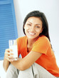 Joven mujer latina bebiendo leche.