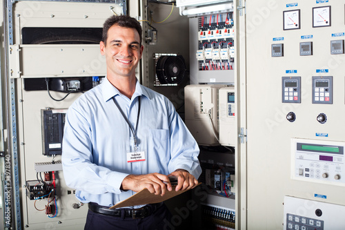 Photo: industrial engineer in front of computerized machine industrial engineer in front of computerized machine