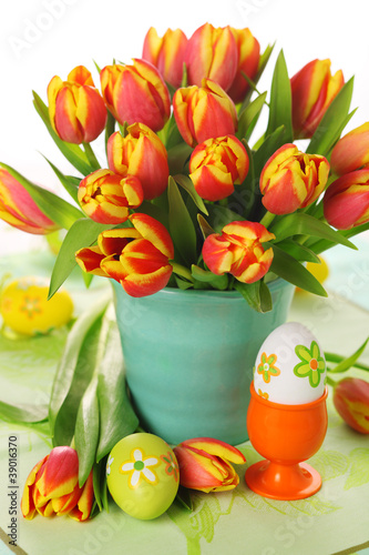 Photo: Beautiful bouquet of tulips in vase with Easter eggs. Beautiful bouquet of tulips in vase with Easter eggs.