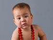 The babe with a red beads.