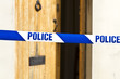 Police tape across an open door