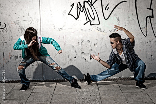 Photo: Young urban couple dancers hip hop dancing fight acting urban Young urban couple dancers hip hop dancing fight acting urban