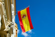 Spanish flag waving at an old building