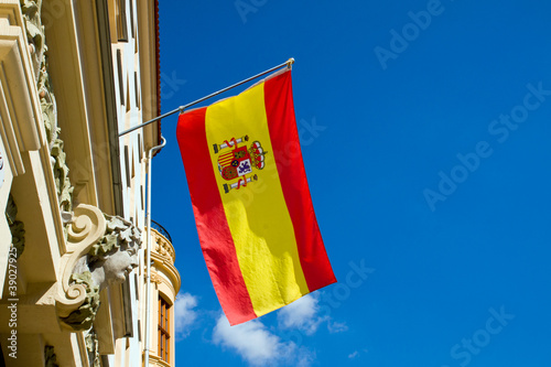Photo: Spanish flag waving at an old building Spanish flag waving at an old building