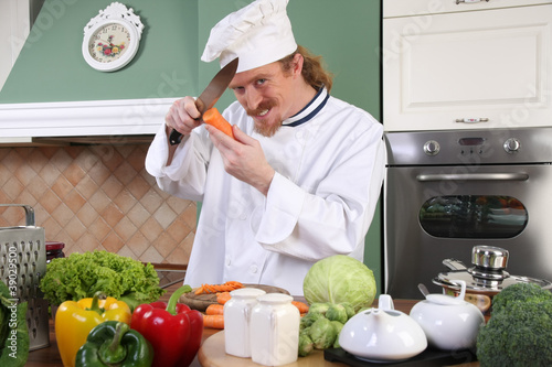 Photo: Young chef preparing lunch in kitchen Young chef preparing lunch in kitchen