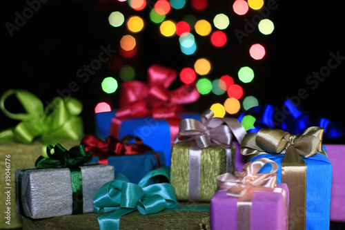 Photo: Gifts on a background of colored balls Gifts on a background of colored balls