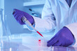 Scientist using pipette in laboratory