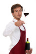 Sommelier holding up a glass of wine