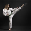 woman - master of karate performs a high kick- 01. woman - master of karate performs a high kick- 01.