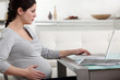 Pregnant woman researching the Internet