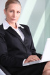 Anxious businesswoman with laptop.