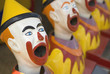 Brightly colored sideshow clowns at a circus..