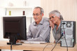 Elderly couple learning computer skills