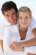 Young smiling couple dressed in white