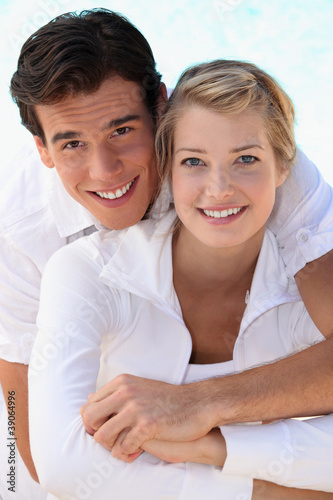 Photo: Young smiling couple dressed in white Young smiling couple dressed in white