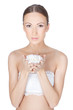 Young beautiful brunette woman holding flower in her hands over
