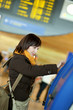 Photo: Girl doing self-checkin in the airport Girl doing self-checkin in the airport