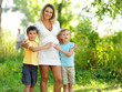 Happy pregnant mother with two sons