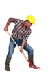 Laborer digging, studio shot